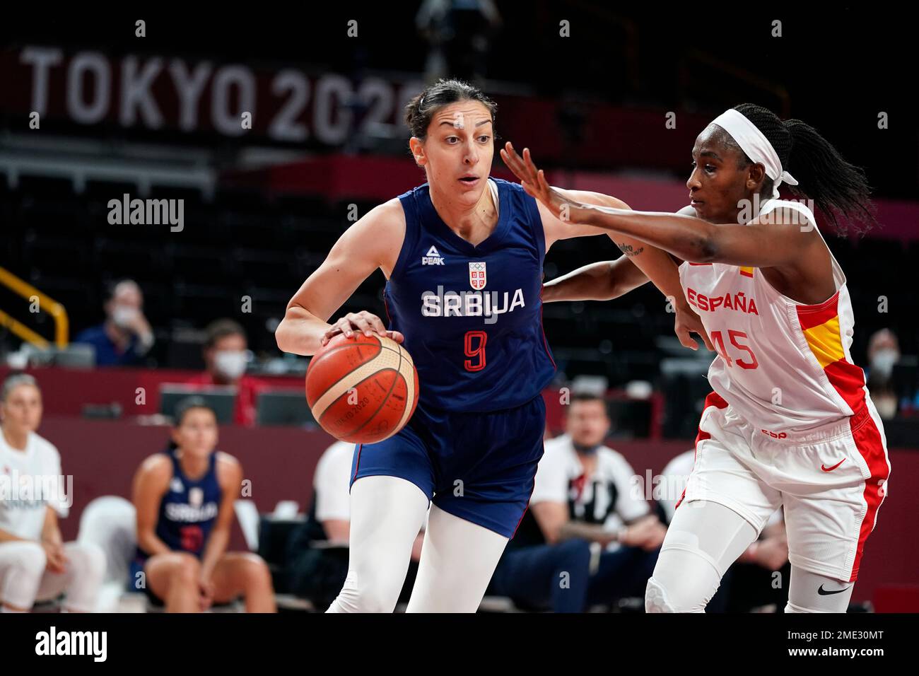 Serbia's Jelena Brooks (9) drives past Spain's Astou Ndour (45) during a  women's basketball preliminary round game at the 2020 Summer Olympics,  Thursday, July 29, 2021, in Saitama, Japan. (AP Photo/Charlie Neibergall  Stock Photo - Alamy