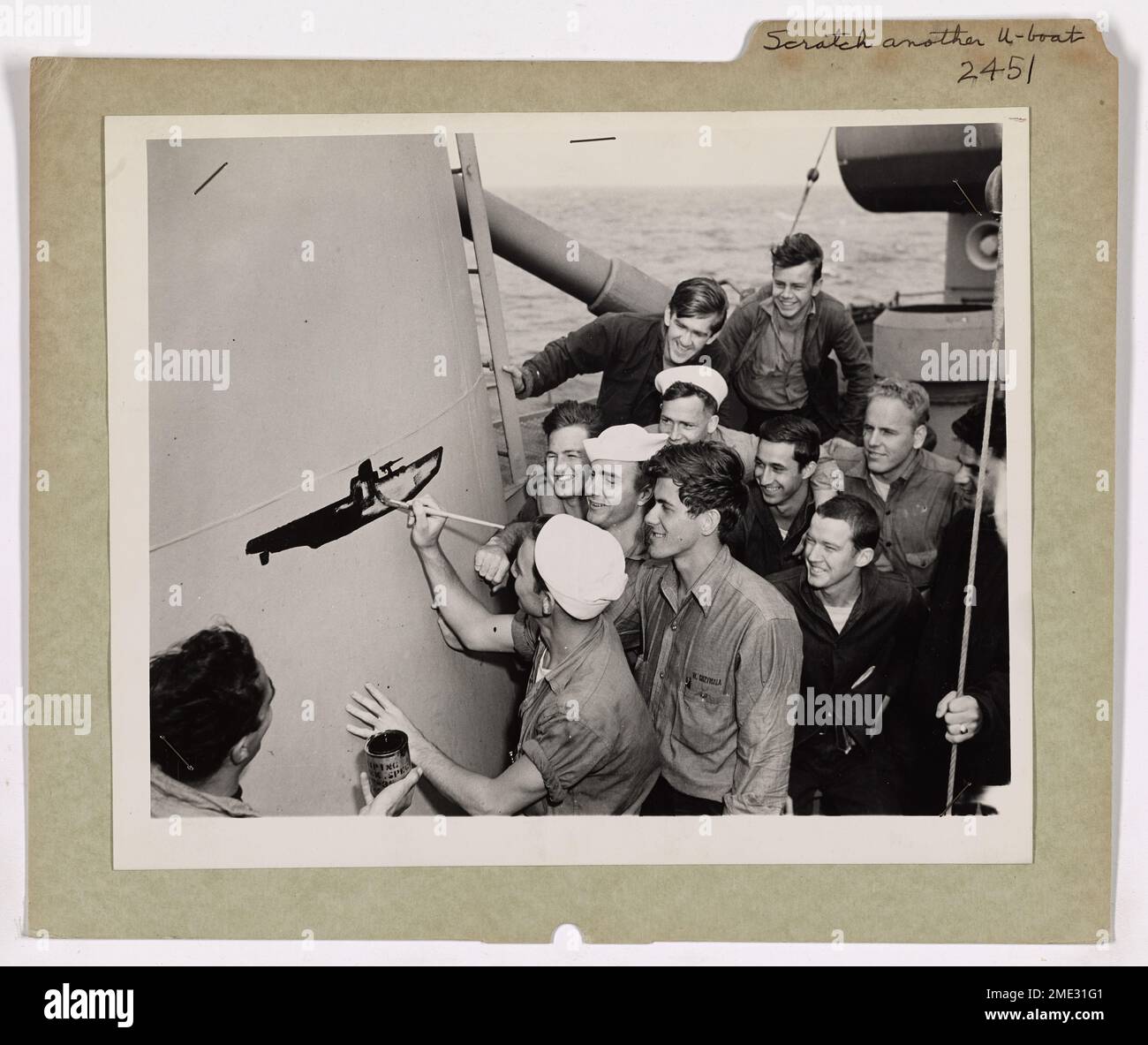 Scratch Another Nazi U-Boat. Jubilant over blasting a German submarine to  the bottom in a recent sea fight, Coast Guardsmen aboard a Coast  Guard-manned Destroyer Escort gather around the scoreboard to chalk