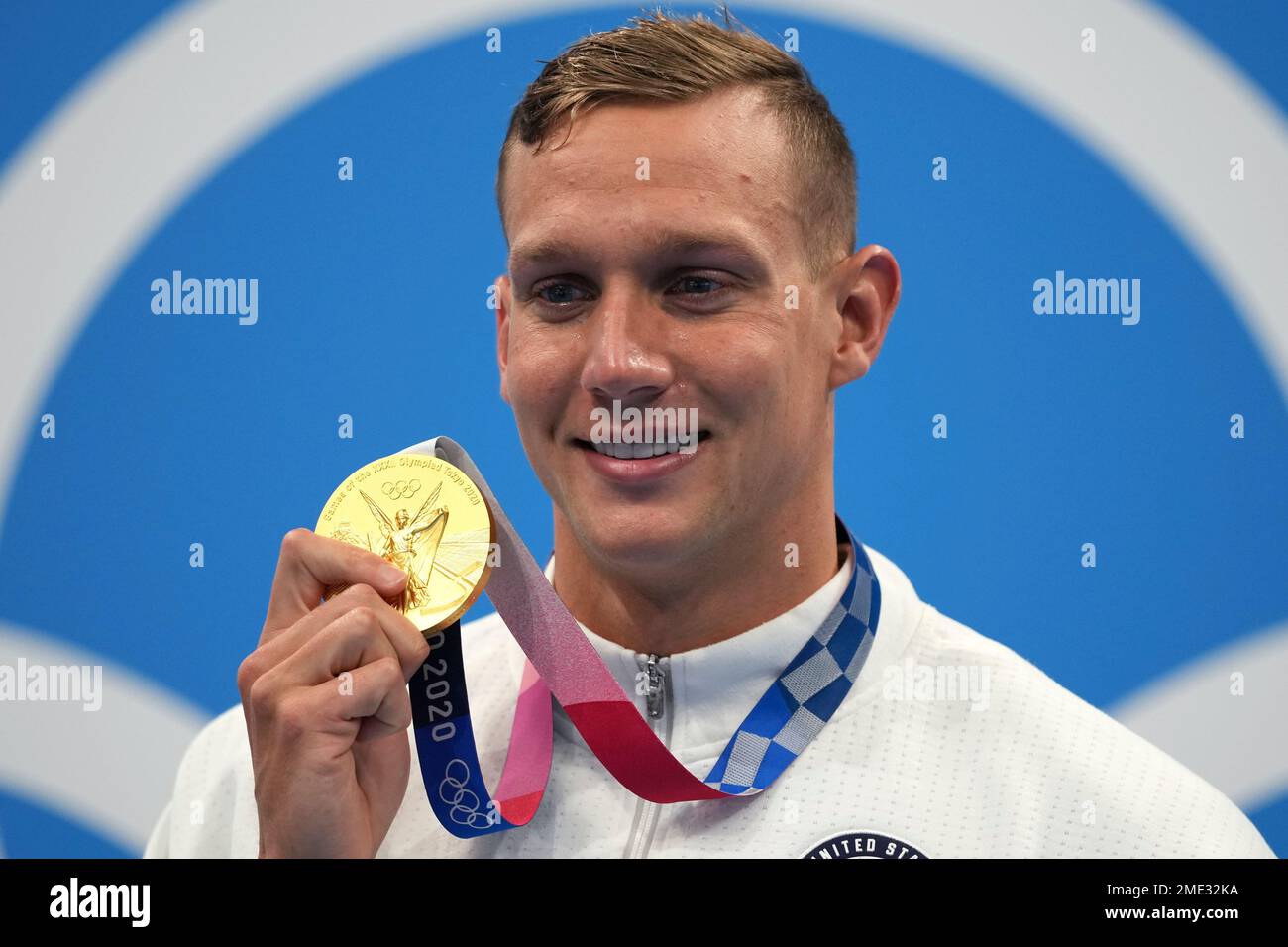 Caeleb Dressel of the United States poses with his gold medal for the ...