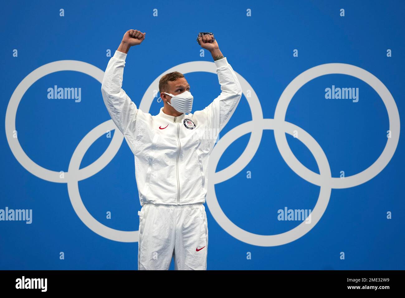 Caeleb Dressel of the United States waves on the podium after winning ...