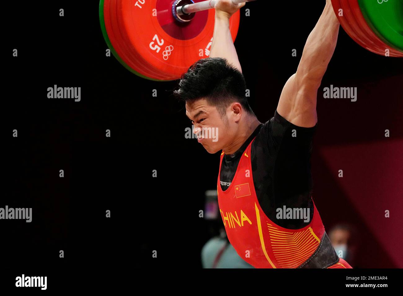 Shi Zhiyong of China competes in the men's 73kg weightlifting event, at