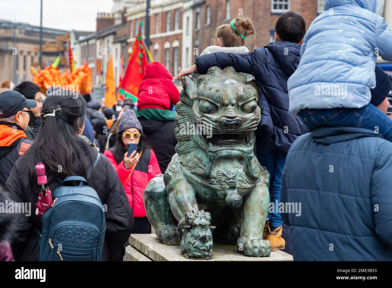 Liverpool, UK - January 22 2023: Lunar Festival, Chinese Year of the Rabbit. Crowds around Fu Dog sculpture on Berry Street. Stock Photo