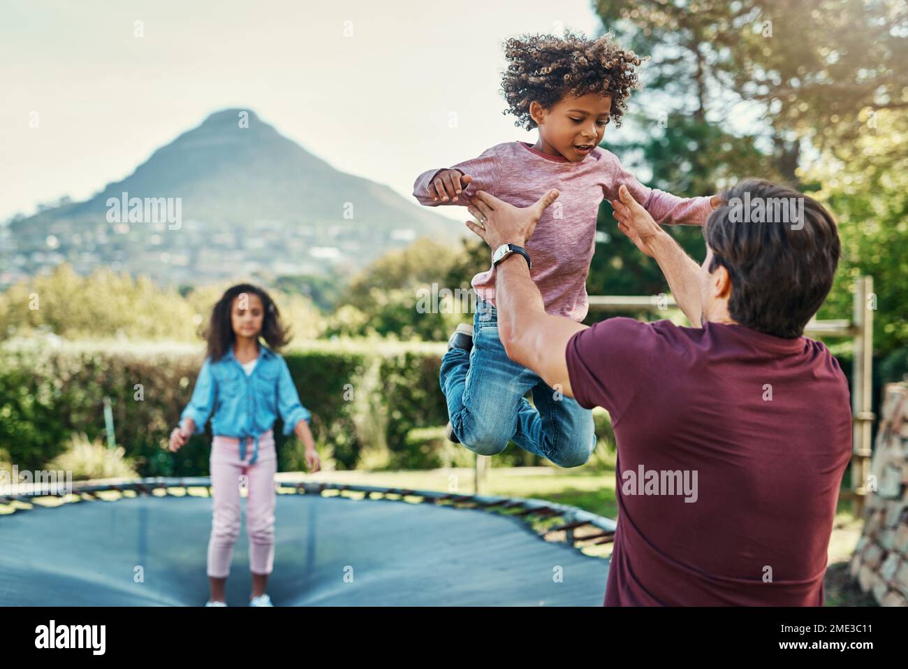 My children mean everything to me. Shot a father playing with his young children at a park outdoors. Stock Photo