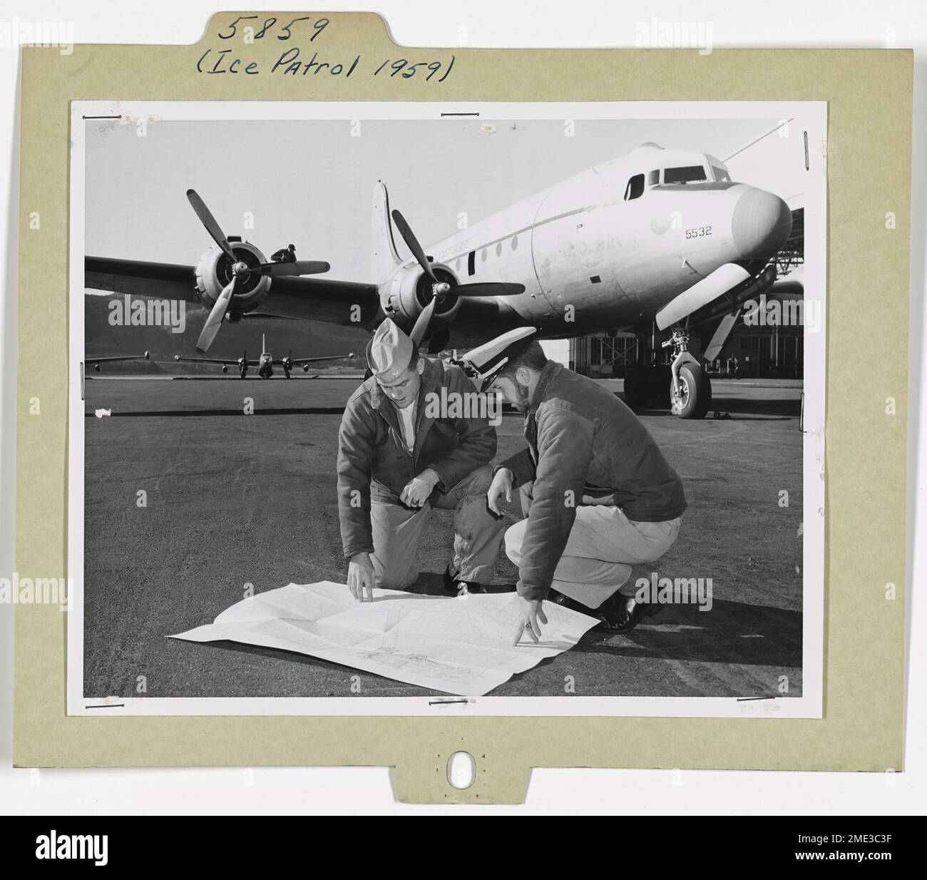 Uscg R5d Ensign Michael J. O'Brien, USCG, reviews flight plans with Ensign ...