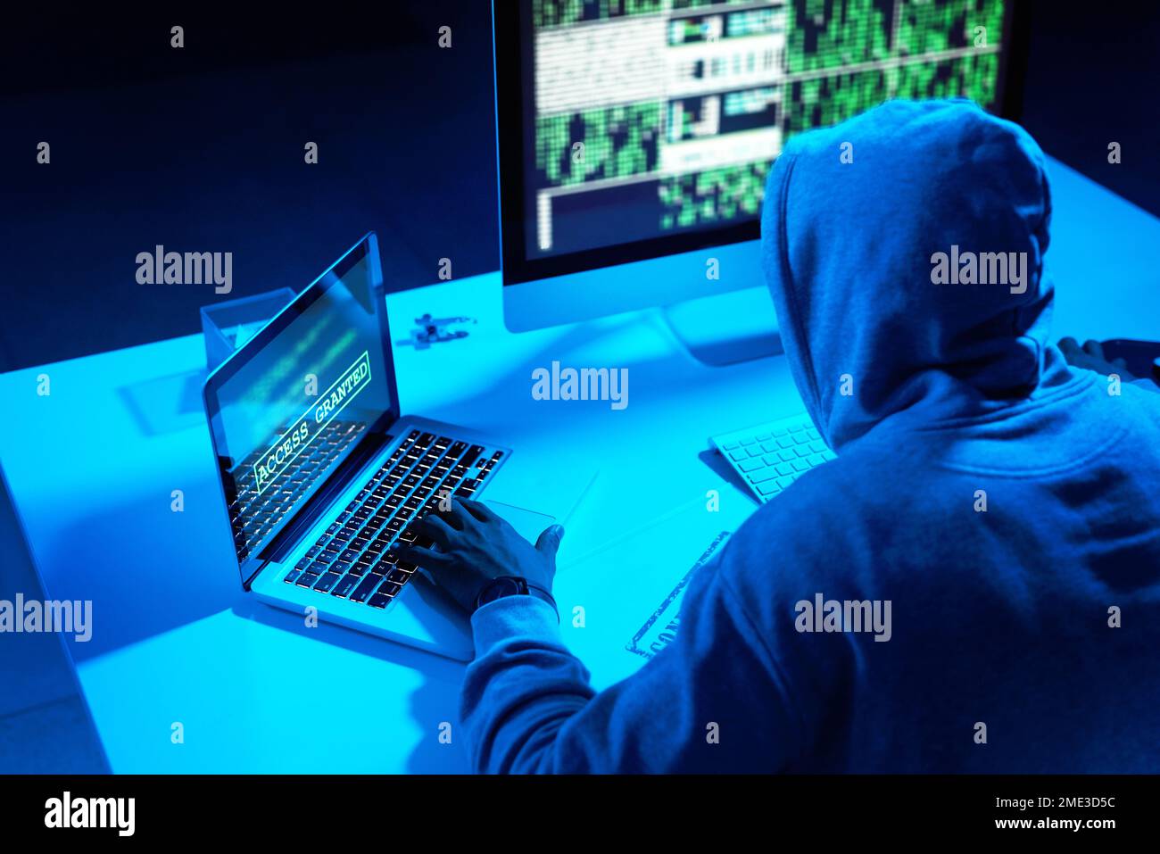Hes in the hacking zone. a young male hacker cracking a computer code in the dark. Stock Photo