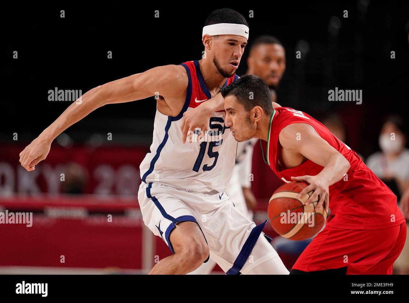 Iran's Mohammadsina Vahedi (3), right, is fouled by United States' Devin  Booker (15) during men's basketball