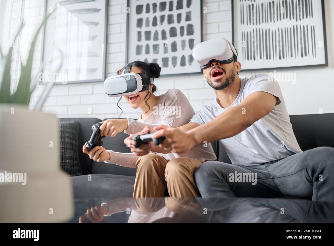 Virtual reality, gaming and metaverse with a couple playing video games in  their home together for fun or enjoyment. VR, game and 3d ai with a man and  Stock Photo - Alamy