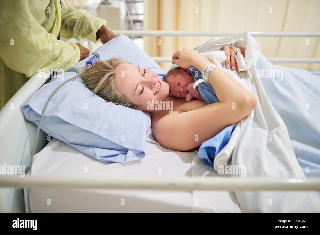 Shes my heart in human form. a beautiful young mother lying in bed with her newly born baby girl in the hospital. Stock Photo