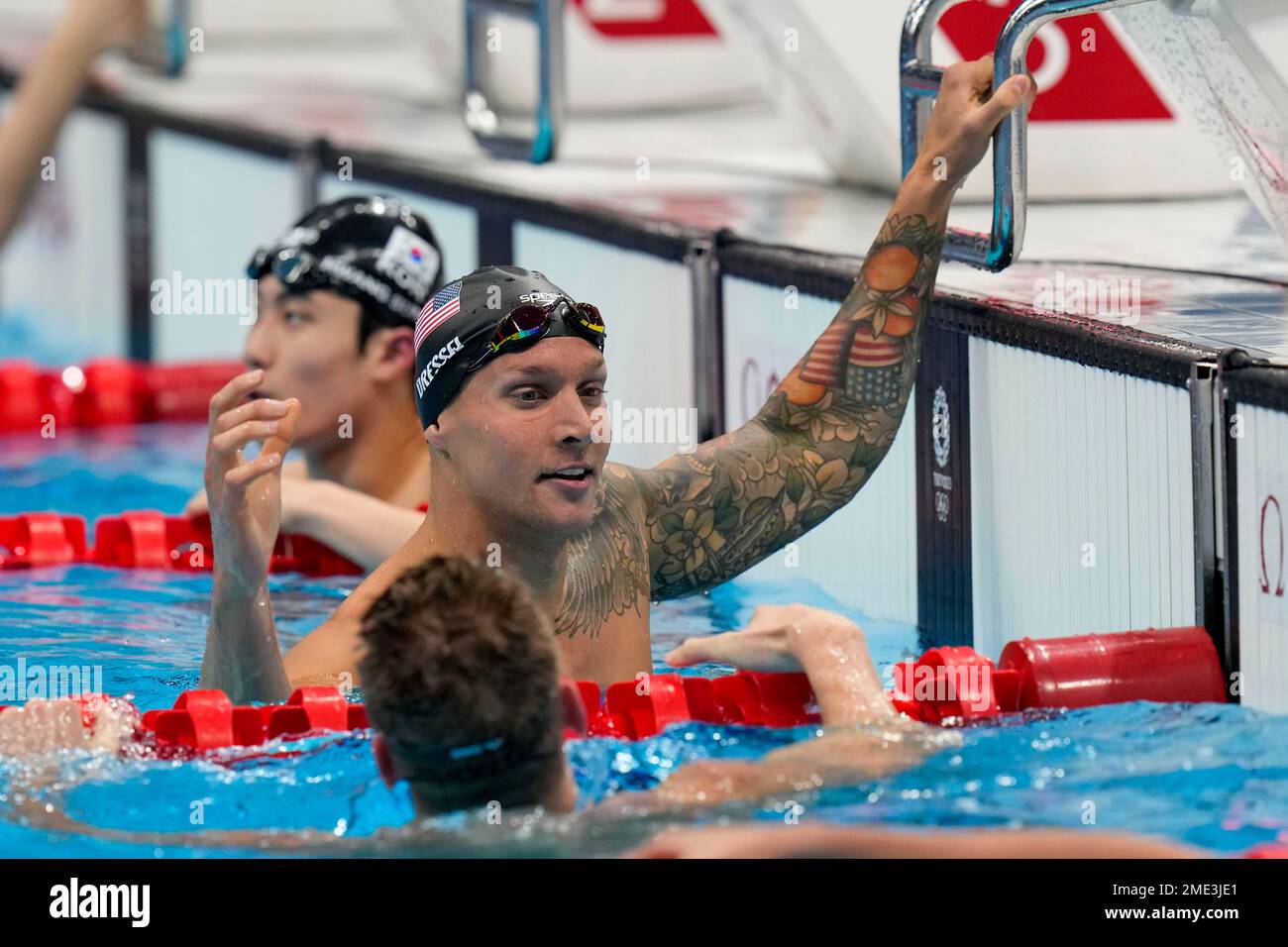Caeleb Dressel, of the United States, reacts after winning a men's 100 ...