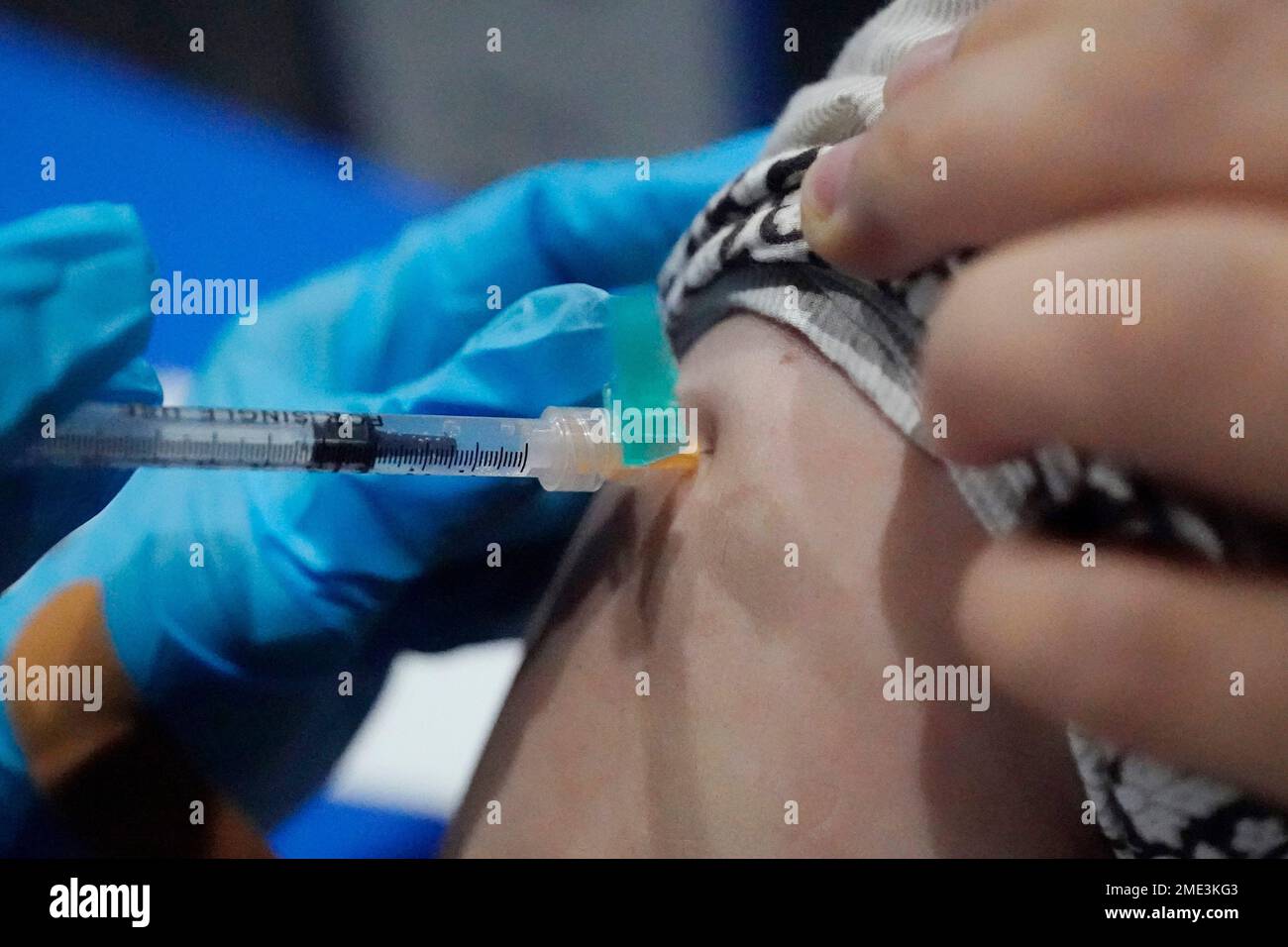 Xiaoli Su, a professor at Jackson State, holds up her sleeve as she