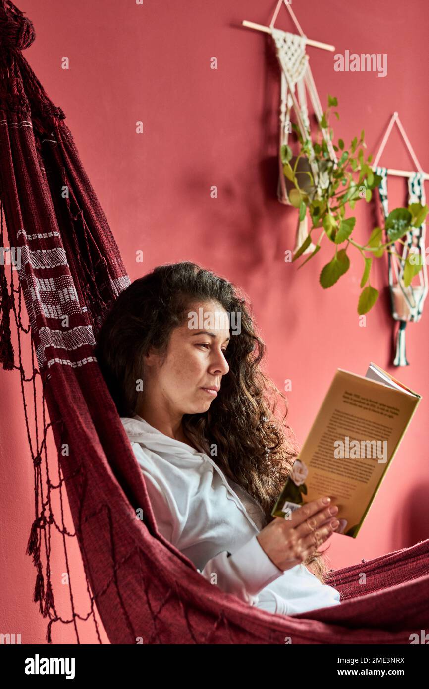 Woman reading in a hammock Stock Photo - Alamy