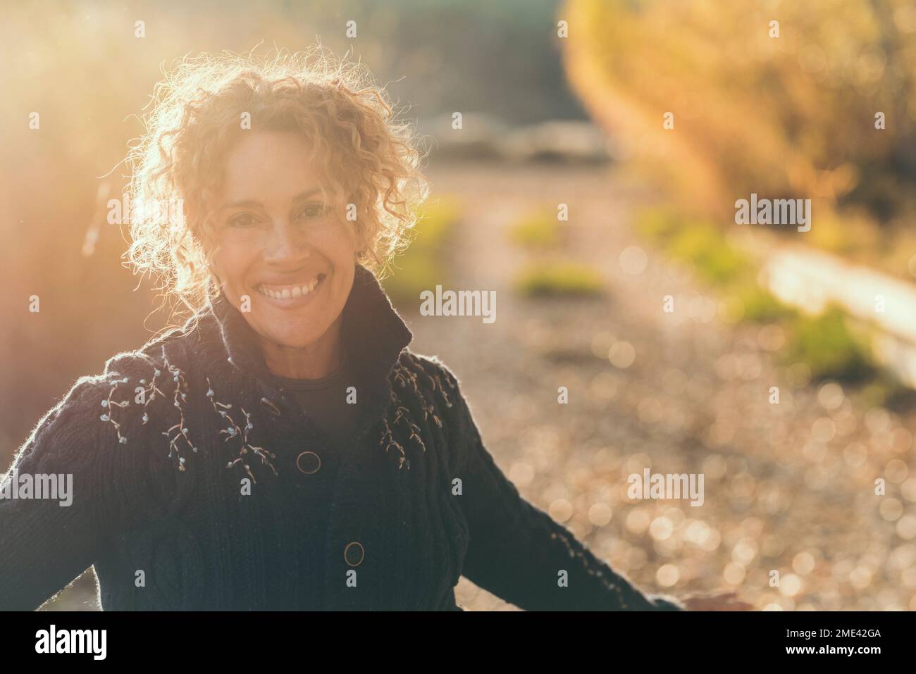happy-mature-woman-with-curly-hair-on-sunny-day-stock-photo-alamy