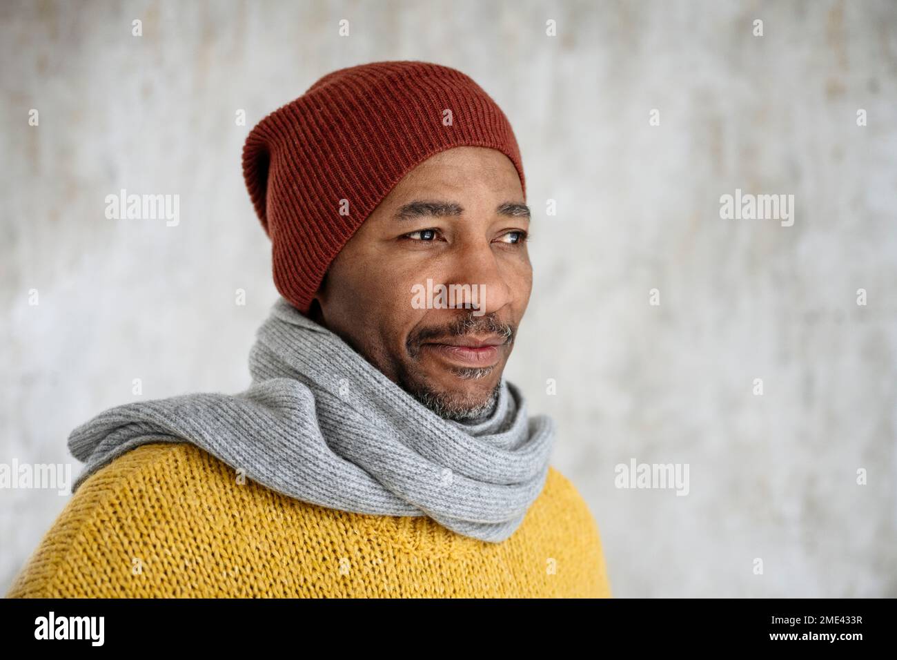 Mature man wearing scarf and knit hat Stock Photo