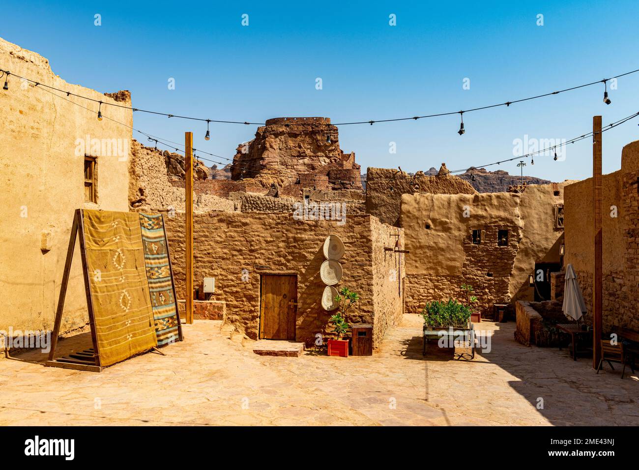 Saudi Arabia, Al-Ula, String lights hanging between mud houses in desert old town Stock Photo