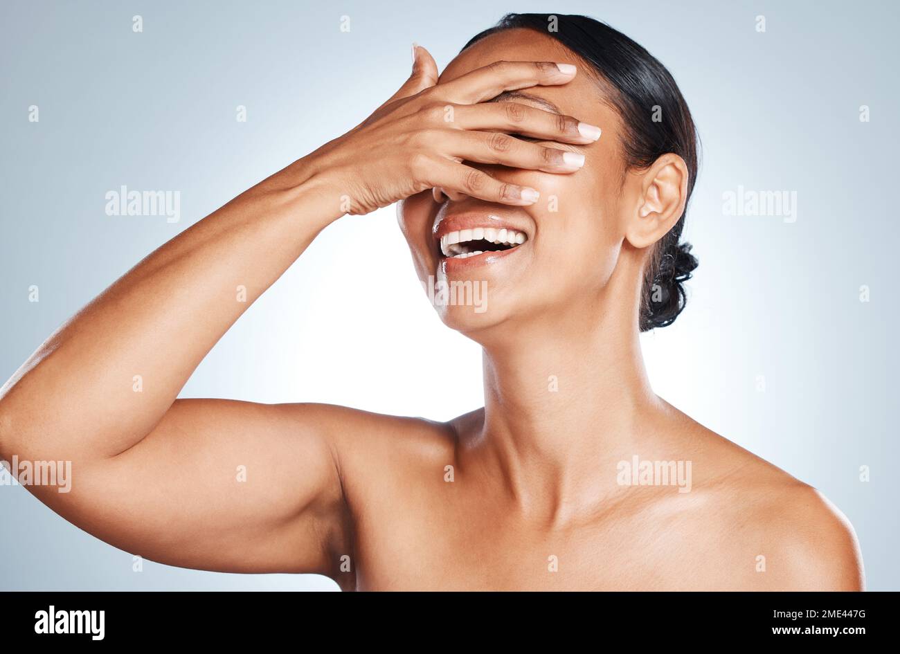 Happy, laughing and woman in studio for skincare, grooming and hygiene against grey background. Beauty, joy and Mexican girl model relax with wellness Stock Photo