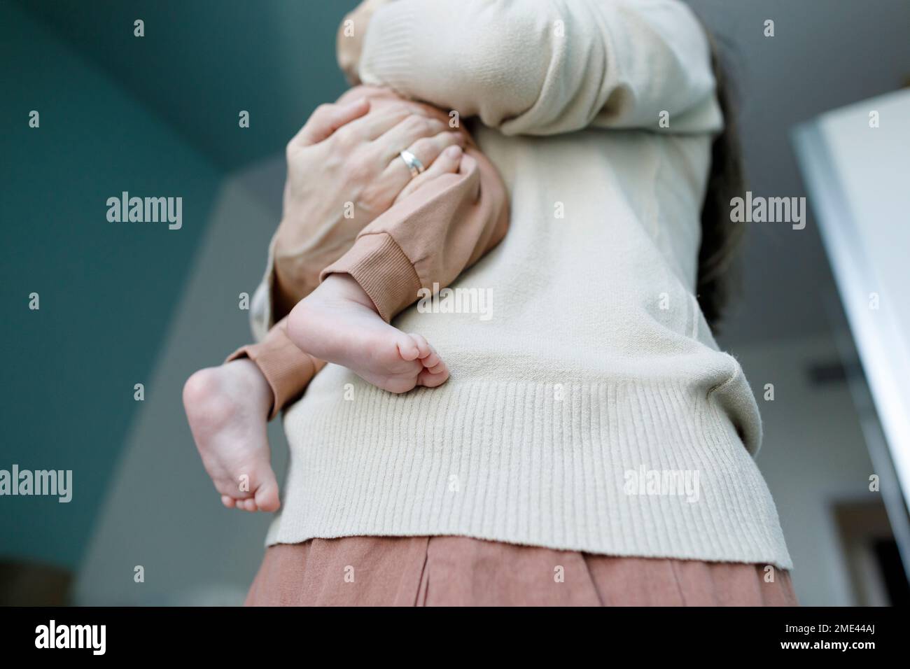 Mother carrying baby boy at home Stock Photo Alamy