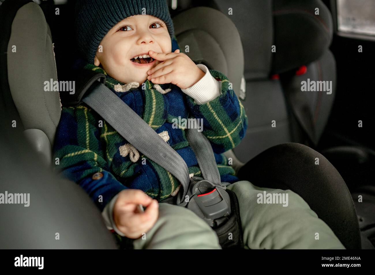 Happy boy in car safety seat Stock Photo - Alamy