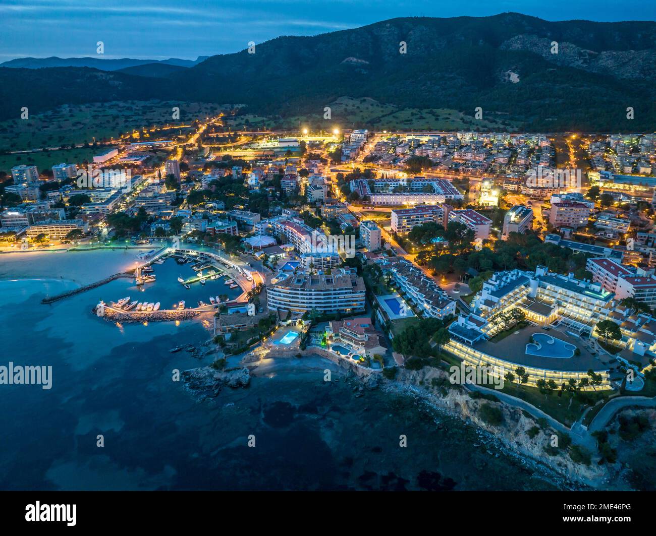 Spain, Balearic Islands, Santa Ponsa, Mallorca, Aerial view of illuminated seaside town at dusk Stock Photo