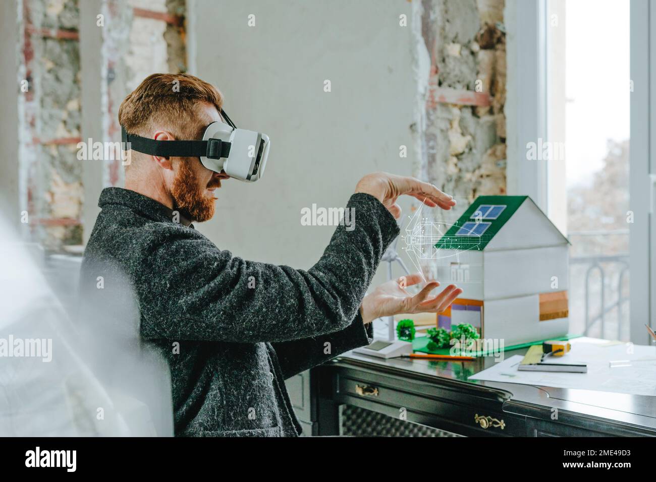 Businessman wearing virtual reality simulator gesturing with wind