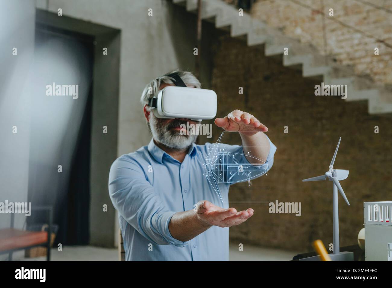 Architect wearing virtual reality simulator gesturing with wind turbine