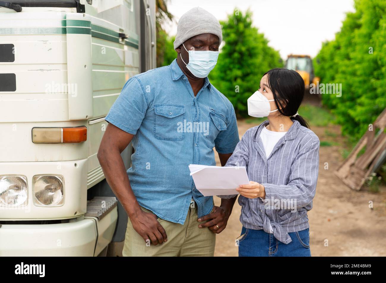 People near truck with mask Stock Photo