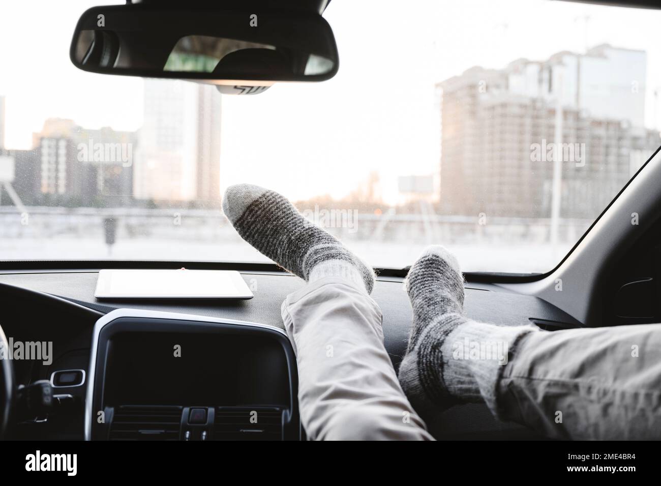 Man with feet on dashboard in car Stock Photo Alamy