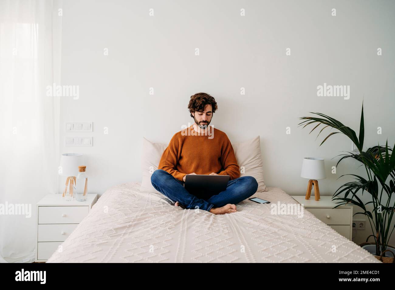 Young freelancer working on laptop at home Stock Photo
