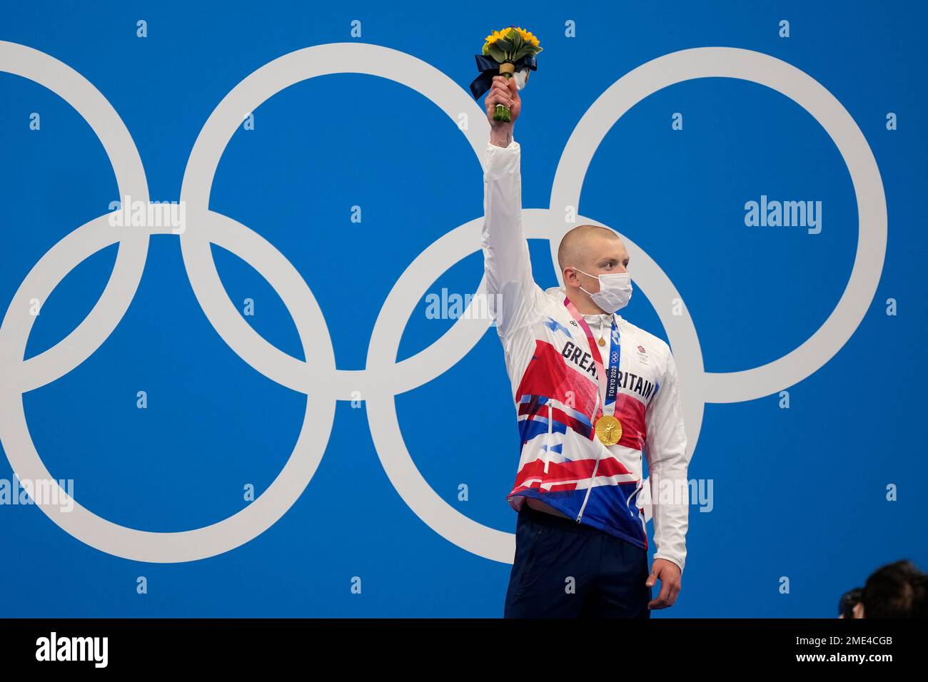 Adam Peaty of Britain celebrates on the podium after winning the final of the men