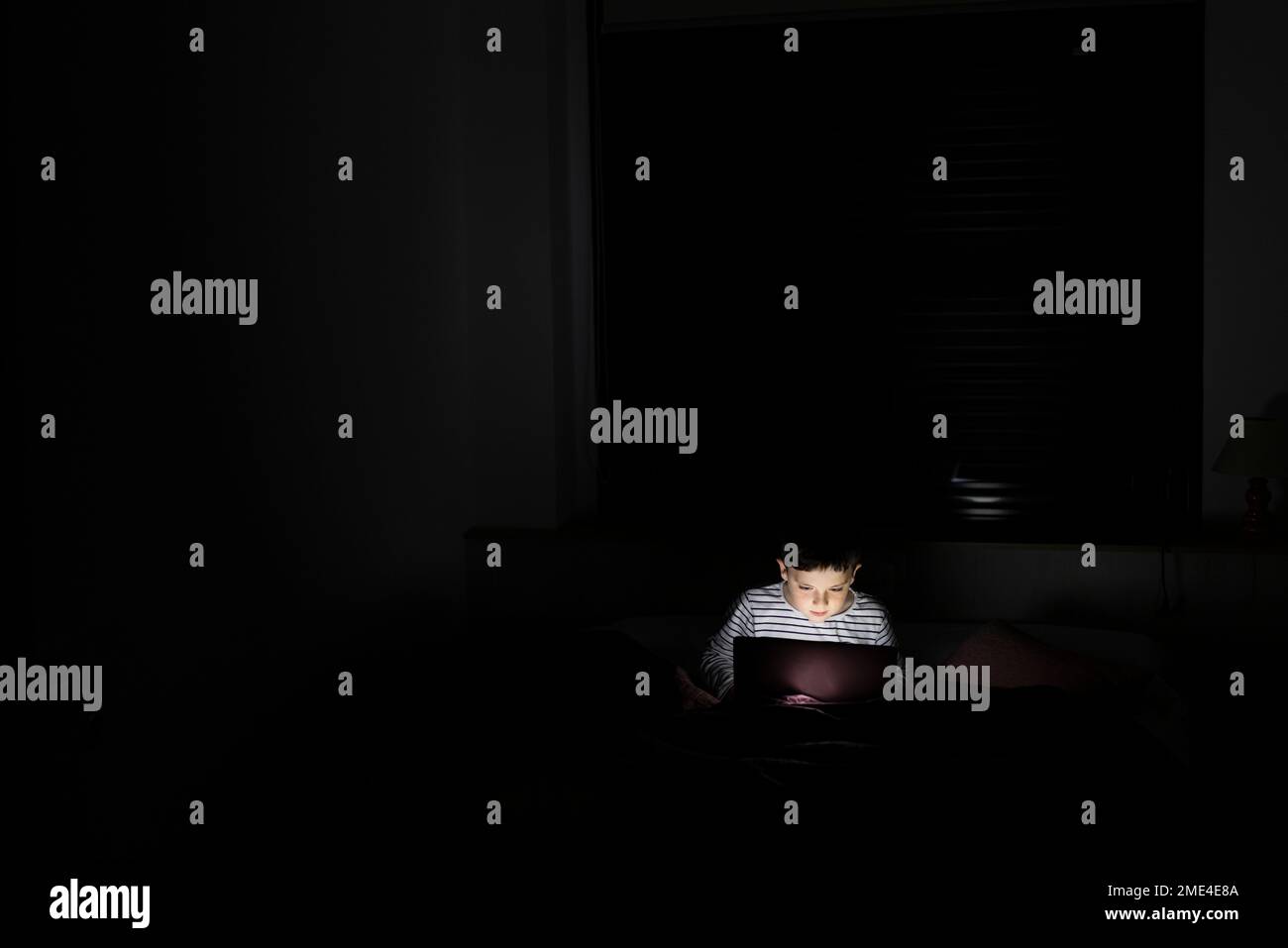 Boy using laptop at home Stock Photo