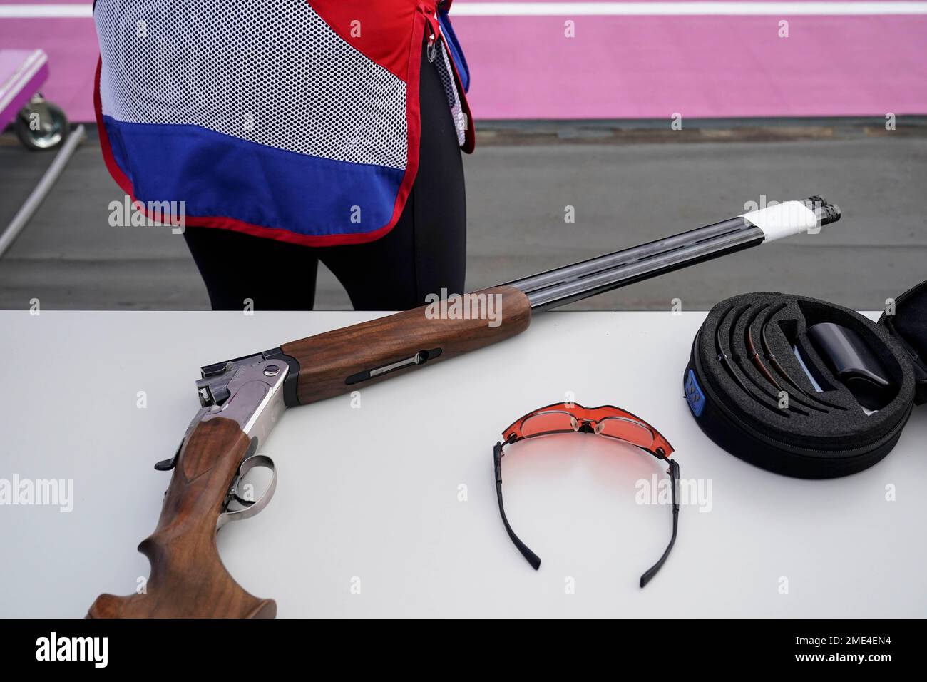 Lucie Anastassiou, of France, checks the tint of her shooting glasses