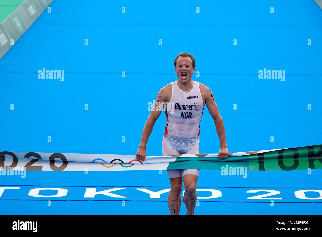 Kristian Blummenfelt of Norway celebrates as he crosses the finish line to win the gold medal
