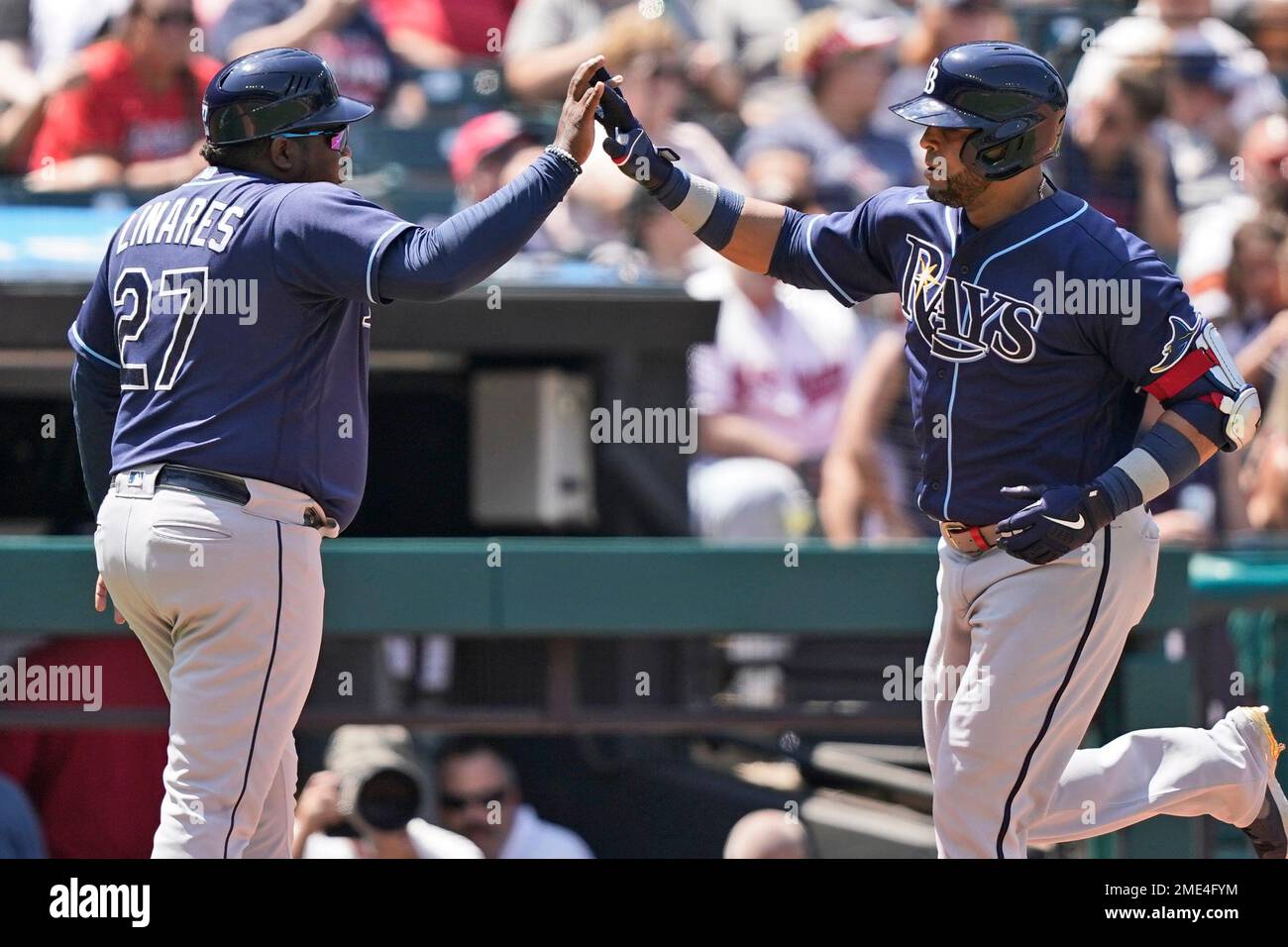 Tampa Bay Rays' Nelson Cruz is congratulated by third base coach