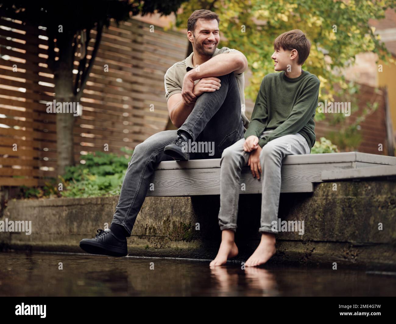 Fathe and son spending time in garden together Stock Photo