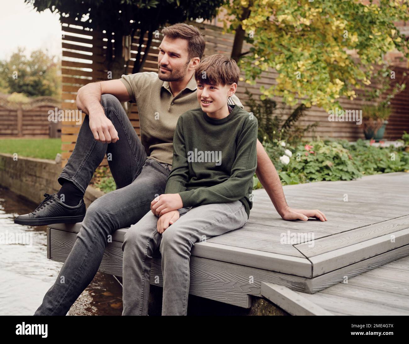 Fathe and son spending time in garden together Stock Photo