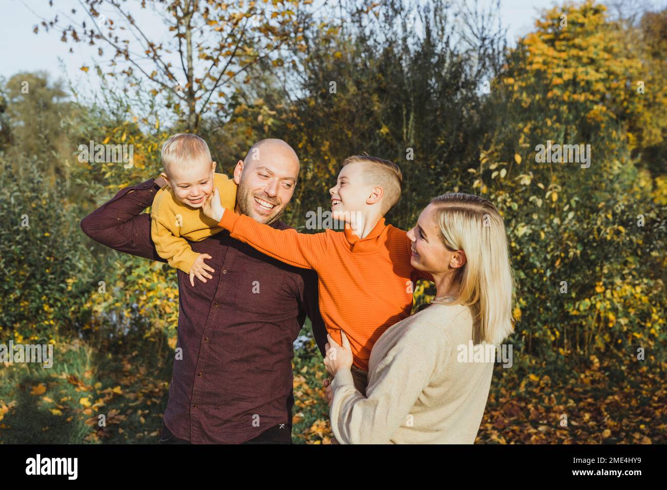 Smiling parents with children enjoying in autumn Stock Photo