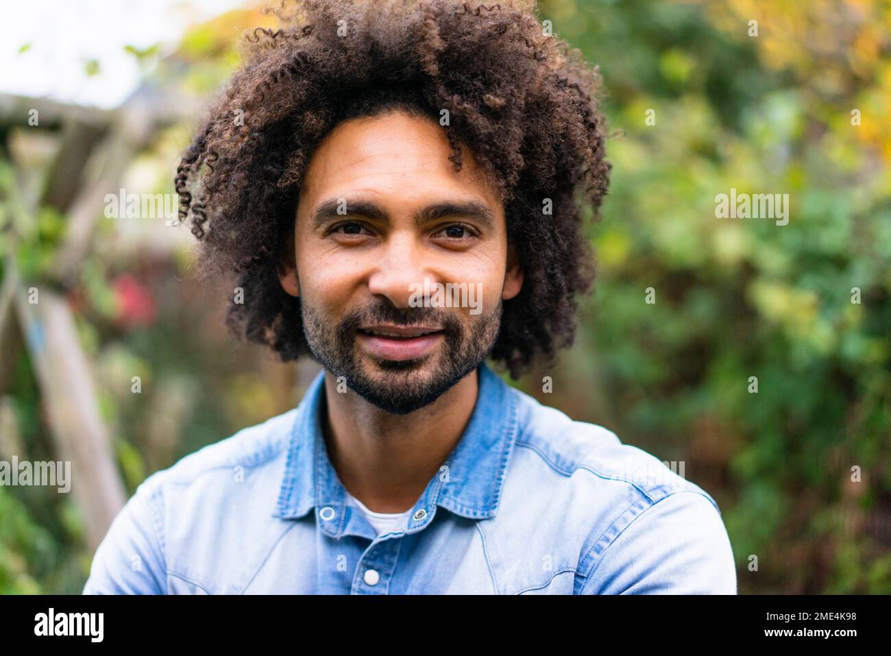 Smiling man with afro hairstyle and beard Stock Photo