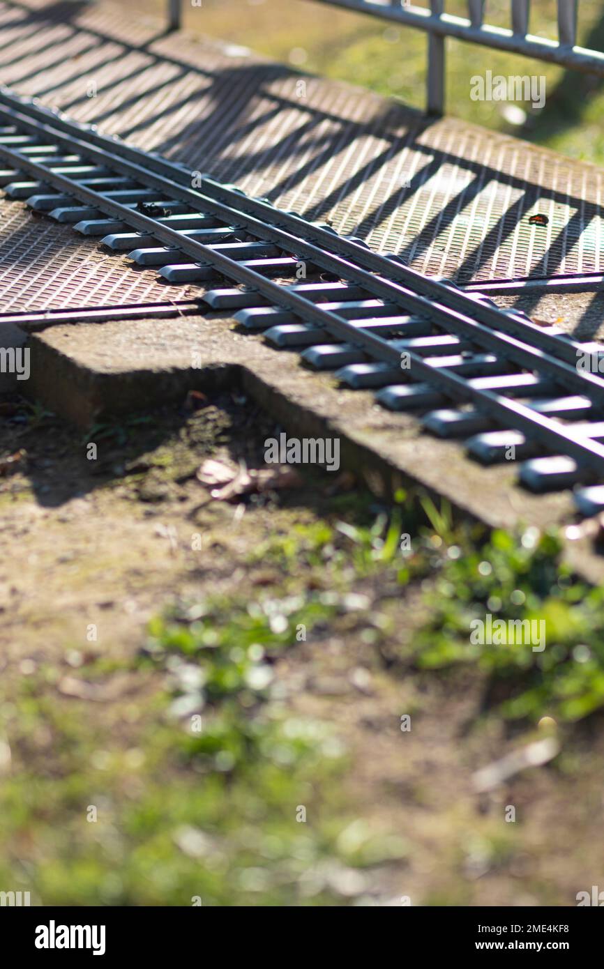 Railroad track crossing a metal bridge on a diagonal perspective Stock Photo