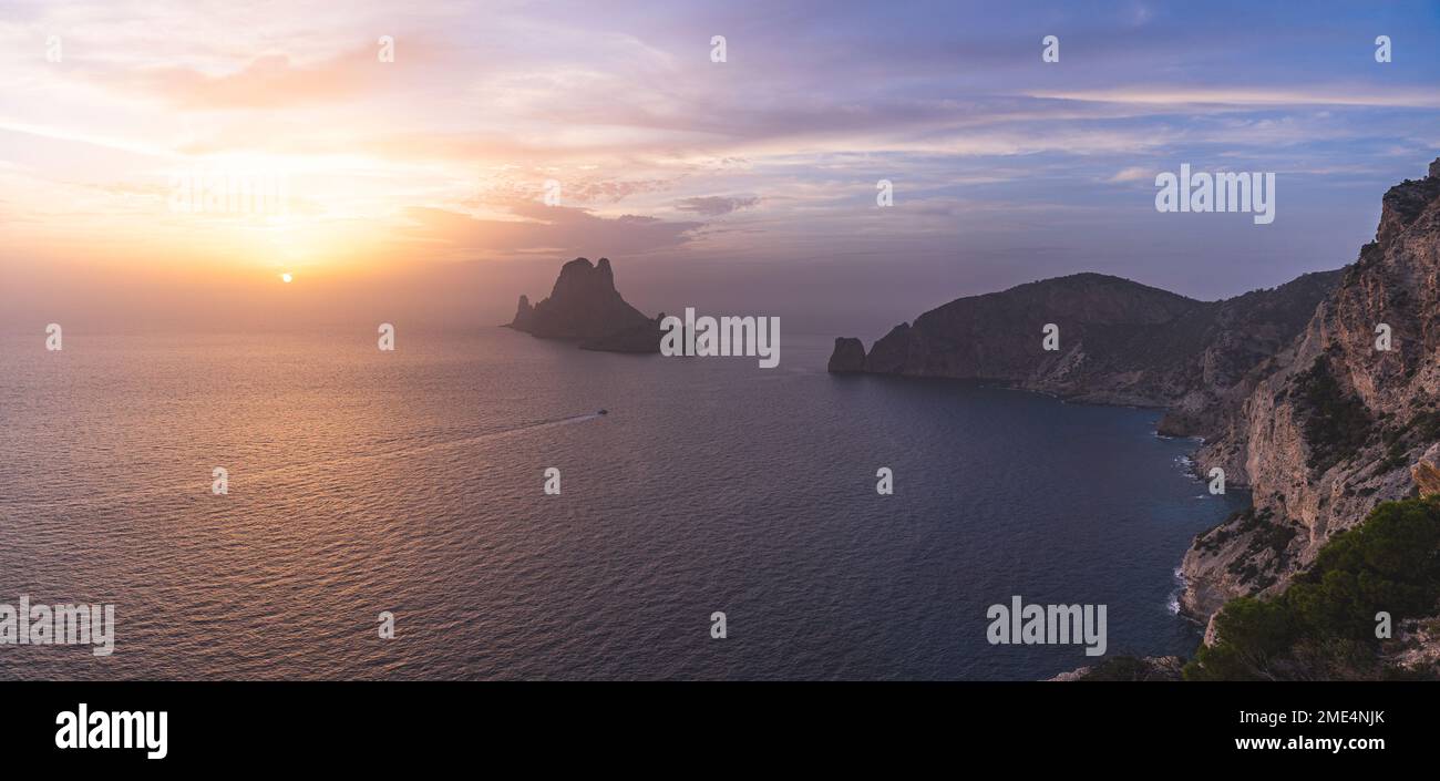 Spain, Balearic Islands, Panoramic view of Es Vedra island seen from clifftop at sunset Stock Photo