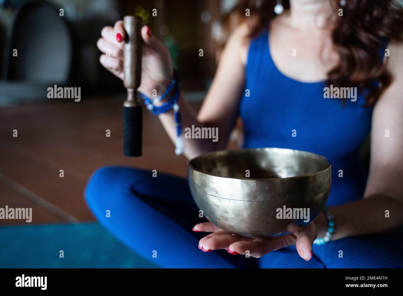 Woman with cross-legged holding Rin Gong bowl Stock Photo