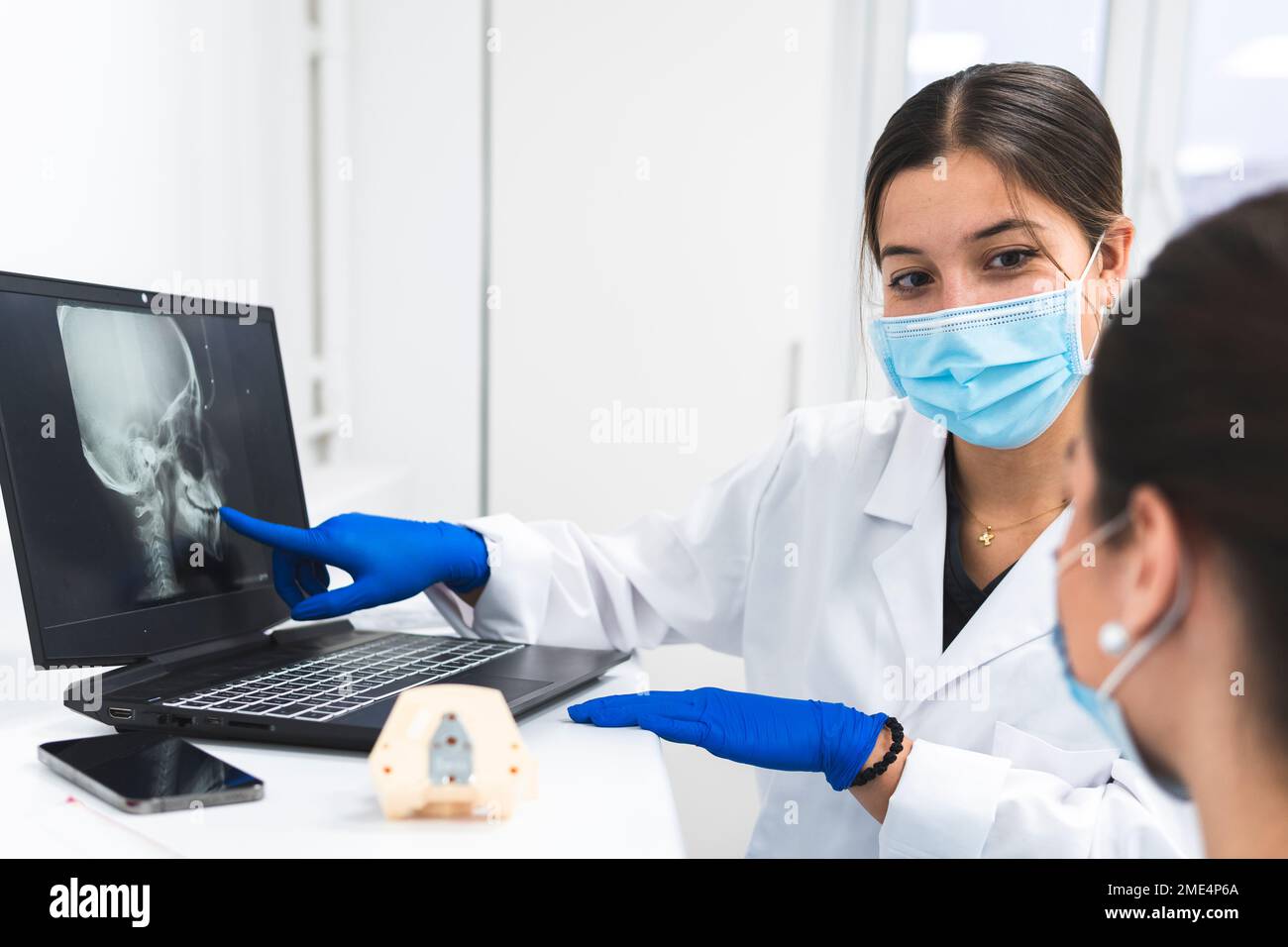 Dentists discussing over x-ray image on laptop Stock Photo