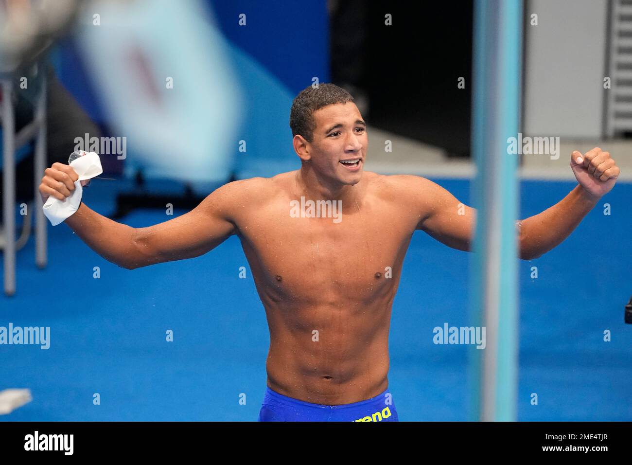 Ahmed Hafnaoui, of Tunisia, celebrates after winning the final of the