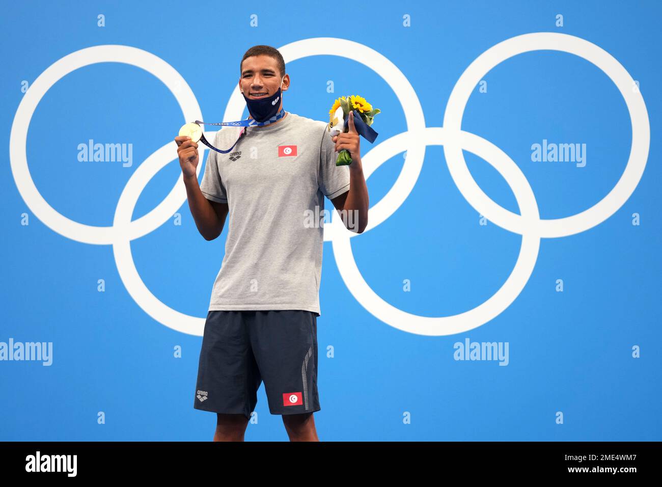 Ahmed Hafnaoui, of Tunisia, poses with his gold medal after winning