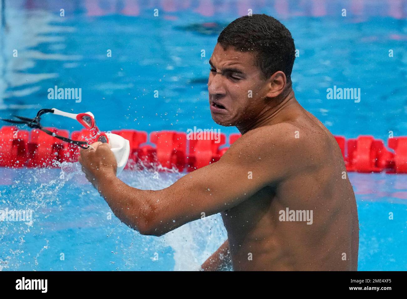 Ahmed Hafnaoui, of Tunisia, celebrates after winning the final of the
