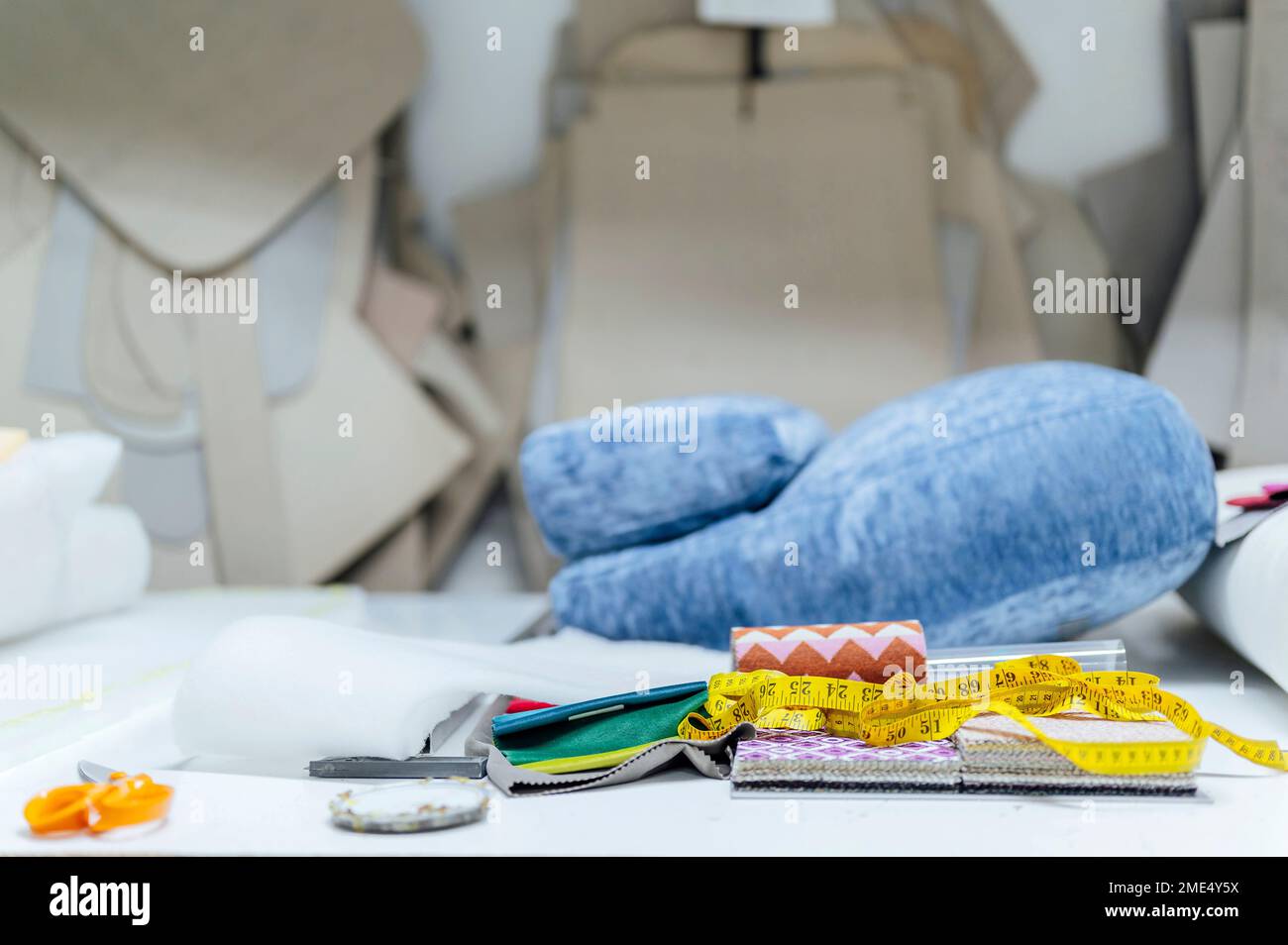 Upholstery workshop with measuring tape and work tools on table Stock Photo