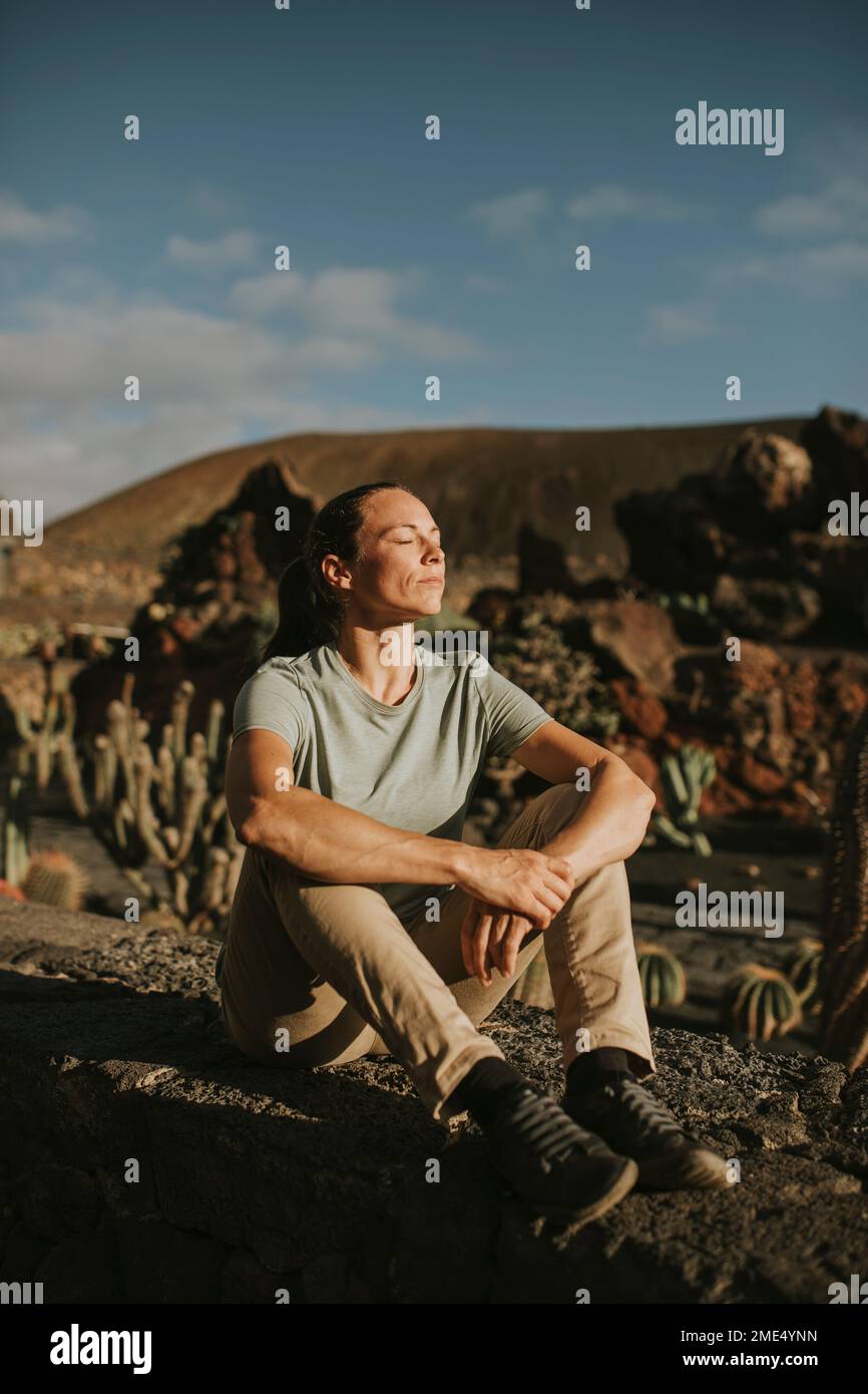Woman sitting on cactus in hi-res stock photography and images - Alamy