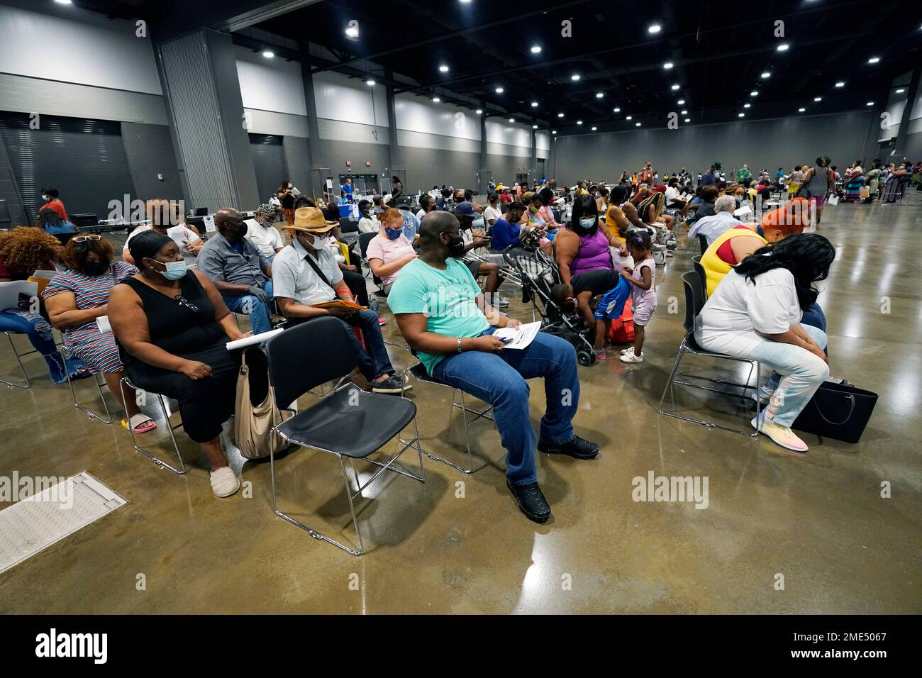 Applicants wait with their paperwork for utility assistance at a rental