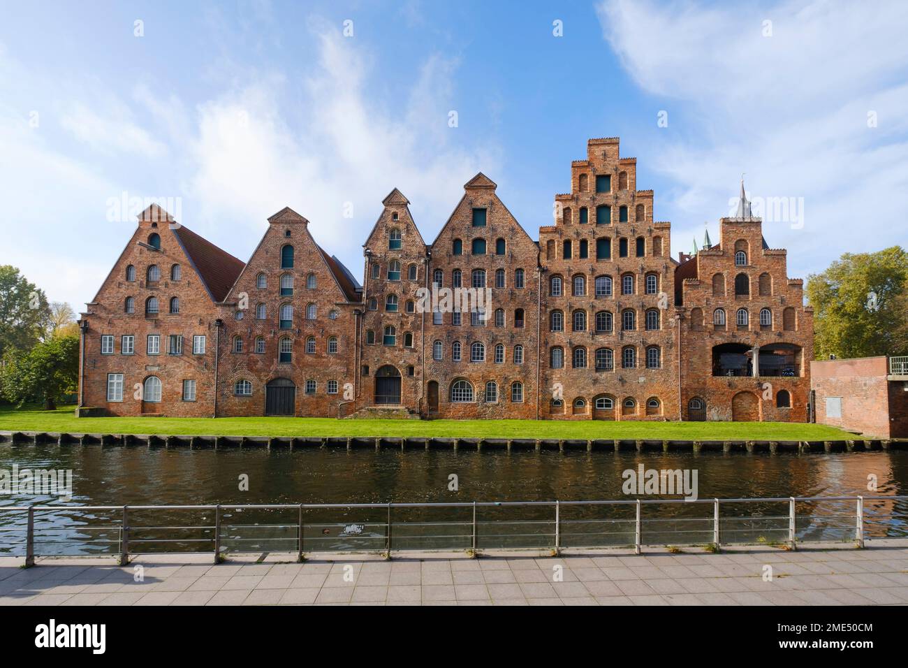 Germany, Schleswig-Holstein, Lubeck, Historic warehouses on bank of river Trave Stock Photo