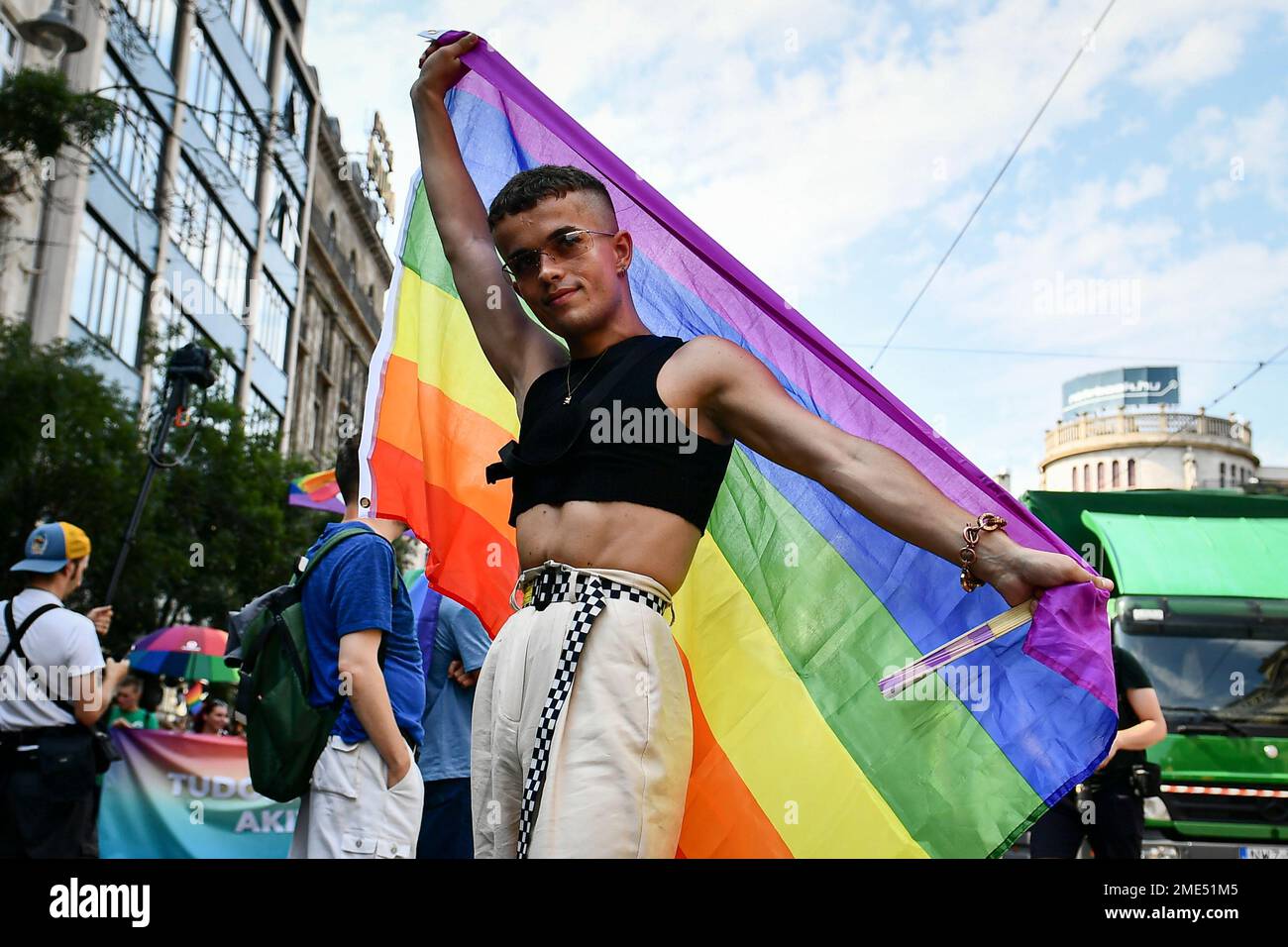 A participant poses with a rainbow flag during a gay pride parade in  Budapest, Hungary, Saturday, July 24, 2021. Rising anger over policies of  Hungary's right-wing government filled the streets of the