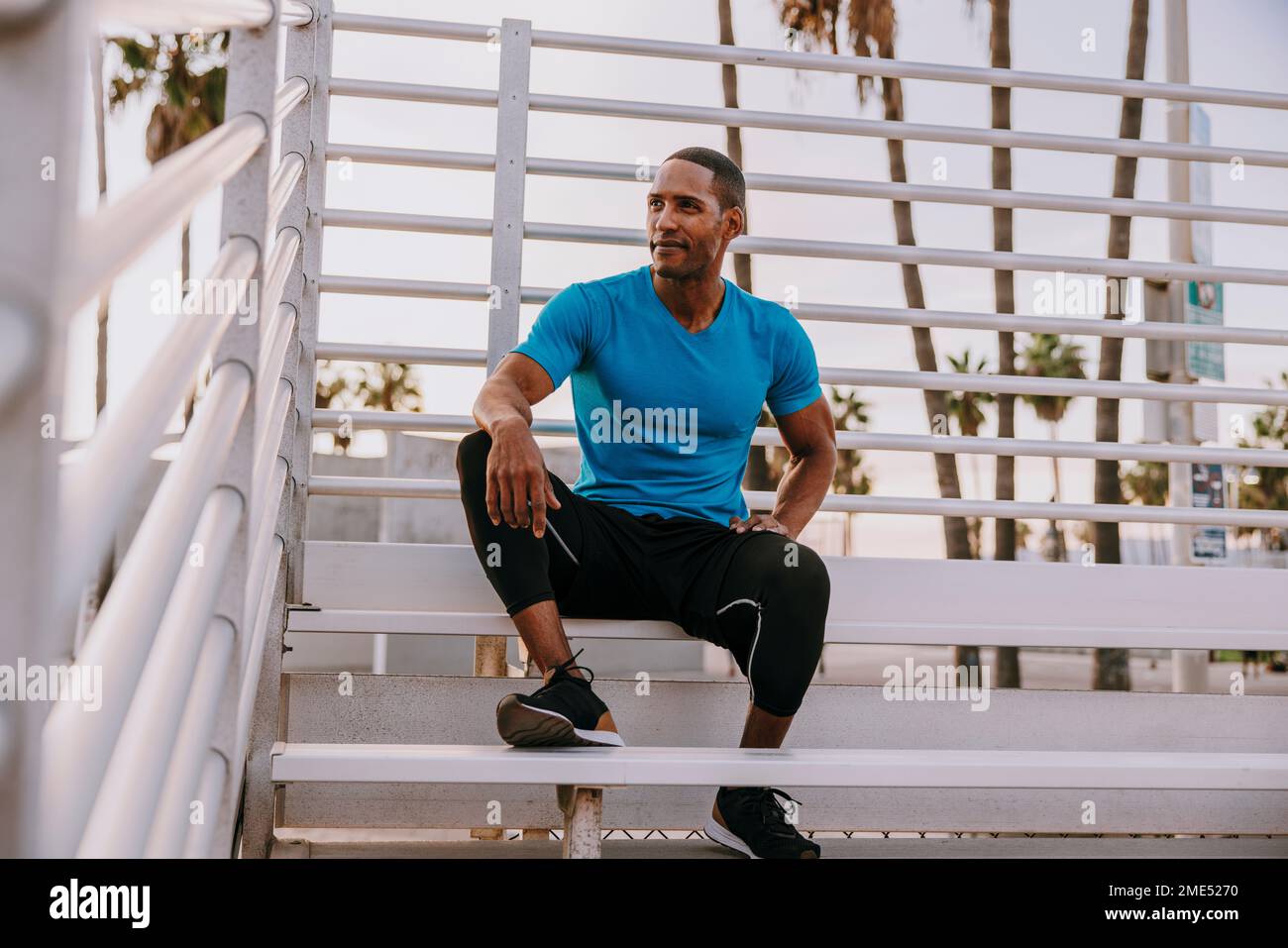 Thoughtful man sitting on steps Stock Photo