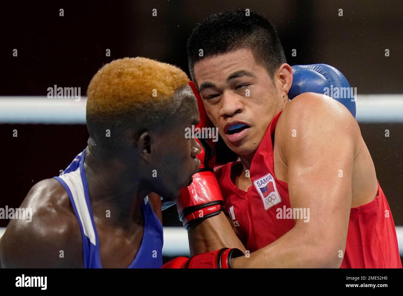 Samoa's Marion Faustino Ah Tong, right, exchanges punches with Zambia's